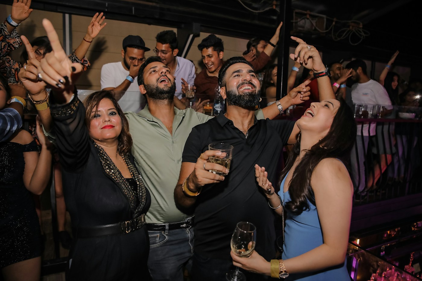 Friends singing and dancing together at an Indian club night — stock mood photograph